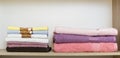 New color towels pile on shelve in wardrobe