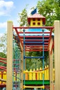 New colorful castle playhouse with climbing frame and rope ladder on children`s playground Royalty Free Stock Photo