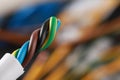 New colorful electrical wire on blurred background, closeup. Space for text Royalty Free Stock Photo