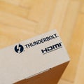 New computer cardboard box on floor with thunderbolt and HDMI