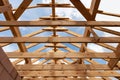 New construction home framing against blue sky, closeup of ceiling frame Royalty Free Stock Photo