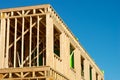 new construction home framing against blue sky, closeup of ceiling frame Royalty Free Stock Photo