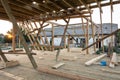 New construction home framing against blue sky at sunset Royalty Free Stock Photo