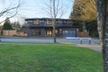 New construction home with low slope roof and brown siding. Royalty Free Stock Photo