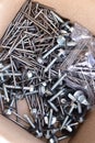 New construction nails and screws in a paper box Royalty Free Stock Photo