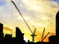 New construction site with cranes on orange sunset, Steel frame structure, structural steel beam build large buildings at Royalty Free Stock Photo