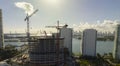 New construction site of developing residense in american urban area. Industrial tower lifting cranes in Miami, Florida Royalty Free Stock Photo