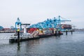 New container terminal with a large container ship and in the foreground a smaller inland container ship in the port of Rotterdam Royalty Free Stock Photo