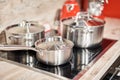 New cookware set on black induction hob in modern kitchen. Pot and frying pan in the kitchen on the hob. cooking concept Royalty Free Stock Photo