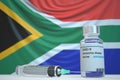 New coronavirus vaccine with flag of South Africa as a background. South African Medical research and vaccination, 3D