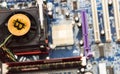 New crypto currency, bitcoin and computer motherboard, cooler Royalty Free Stock Photo