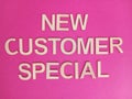 New customer special sign on a pink background