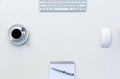 New Day at Office Concept White Table with Computer Blank Notepad and Cup of Coffee Top View Royalty Free Stock Photo