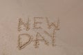 New Day words - drawing on the sand, handwritten on the sea beach sand Royalty Free Stock Photo