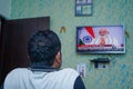 New delhi, Delhi/ India- June 30 2020: A man watching the live Tv of Prime minister Narendra Modi's announcement about Unlock Royalty Free Stock Photo