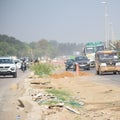 New Delhi, India - April 16, 2023 - View of Vehicles passing through the main road near Indra Gandhi International Airport Delhi