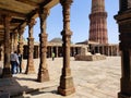 Sunlight and shadows formed at the ancient Hindu temple corridor with beautifully carved stone pillars. Royalty Free Stock Photo