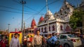 Busy traffic and people at Chandni Chowk market downtown in Old Delhi, India with Red Fort