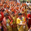 New Delhi, India April 03 2022 - Women with Kalash on head during Jagannath Temple Mangal Kalash Yatra, Indian Hindu devotees Royalty Free Stock Photo