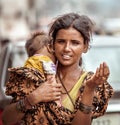 New Delhi, India - August 14, 2016: Young indian beggar woman with baby begs the alms in New Delhi, India