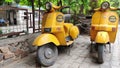 New Delhi, India. Fancy /quirky yellow colored Bajaj scooters parked used for food delivery by Fat Albert restaurant