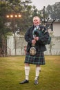 Scottish piper from Scotland in traditional outfit with tartan kilt playing bagpipe Royalty Free Stock Photo