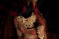 High angle shot of a modest woman with black hair in traditional clothing on dark background