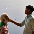 New Delhi, India - March 04, 2020: Handsome old man shaving his beard in bathroom during morning time at Yamuna river ghat in New