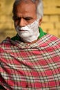 New Delhi, India - March 04, 2020: Handsome old man shaving his beard in bathroom during morning time at Yamuna river ghat in New
