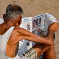 New Delhi, India - March 04, 2020: A man reading Hindi newspaper during morning time at Yamuna river ghat in New Deli, India, Yamu Royalty Free Stock Photo