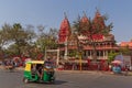 NEW DELHI, INDIA - MARCH 13, 2018: tuk-tuk on street in front of temple Royalty Free Stock Photo