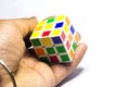 New Delhi, India - November 10, 2019. Coins And Rubik& x27;s cube on white background with space