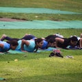 New Delhi, India, May 31 2023 - Group Yoga exercise class Surya Namaskar for people of different age in Lodhi Garden,