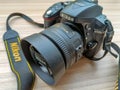 New Delhi, India, May 28 2023 - Nikon D5300 camera with 35mm f2.8 prime lens on plain background, Nikon DSLR camera shoot