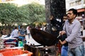 Street food vendor cooks noodles in a wok at Nehru Place market in South Delhi India, known