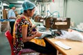 New delhi, India - 10 september 2019: an indian woman at work using industrial equipment inside packaging manufacturing plant