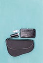 New design black purse with cosmetic on blue background Royalty Free Stock Photo