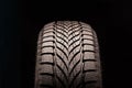 New directional friction winter tire Velcro without spikes on black background. rubber for ice water and snow. seasonal change of