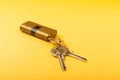 New door lock on a yellow background. Patent and keys from the front door. Royalty Free Stock Photo