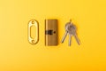 New door lock on a yellow background. Patent and keys from the front door. Royalty Free Stock Photo