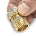 New double G 1/2& x22; tube adaptor threaded connector, in hand of a specialist on white background