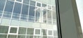 New double-glazed windows and glass windows in the school. View from the window to the opposite wall and windows. Silhouettes of Royalty Free Stock Photo