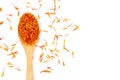 New Dried Safflower petals herb Tea on a wooden spoon.  on a white background Royalty Free Stock Photo