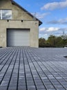 New driveway to private house built with paving stones with special spacing teeth