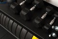 New dumbbells lying in row on rack in gym Royalty Free Stock Photo