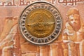 The new Egyptian Suez canal project slogan from the obverse side of 1 LE EGP coin one Egyptian pound money on a blurred background