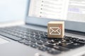 New email symbol on wooden block on laptop keyboard