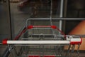 New empty metal shopping cart outdoors, closeup Royalty Free Stock Photo