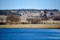 New England farm with windmill and lake