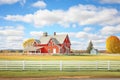 new england farmhouse with a red barn and splitrail fence Royalty Free Stock Photo